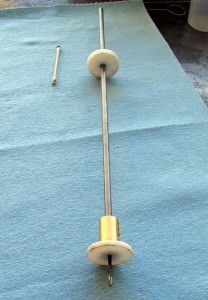 Photo #4: Step one to persuade a stuck ball out of the cannon: drill a hole in the outward most end. Had to make this drill extension and coupling to do the deed. Extension is 1/4″ and drill bit is 1/8″. To make sure the hole was in the center of the ball I whipped up a couple of Delrin disks to keep the drill on target.