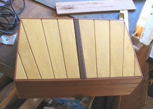 Photo #11: View of display box from above. Top is made from Yellowheart pieces, tapered and bevelled on their mating edges. Sides are made of Honduran Mahogany, with Purple Heart trim. Center post is Cocobolo.