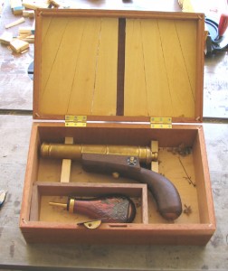 Photo #10: Here’s the popgun in my partially-made display box. The gun lacks a trigger so it’s technically a hand cannon, requiring a lit fuze to fire. Bore is .75 caliber, but the massive barrel makes the kick barely noticeable. In fact it’s so heavy I intend to make a monopod to support it. I’m thinking it would be kewl to make something similar to what was used to support an arquebus. Have yet to figure out how to dress box lid on the inside; first I’m fitting the latch.
